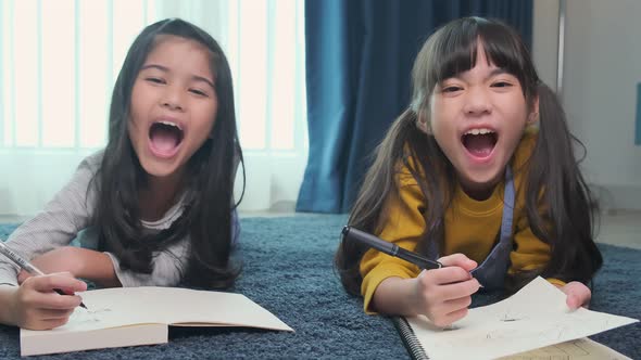 young asian daughter sibling child happiness lay down study online e-learning