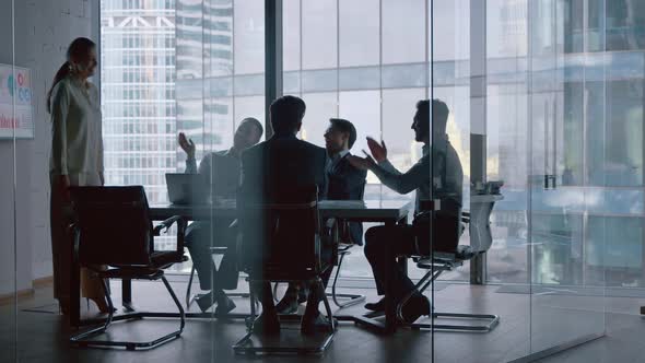 Applause for mature businesswoman after presentation about business strategy in meeting room