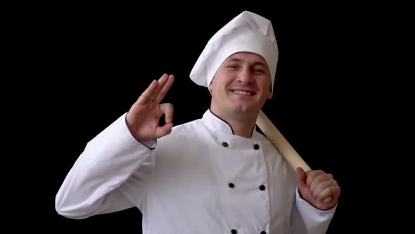 Adult White Male in Chef Suit on Black Background Shows Sign with Hands Perfectly