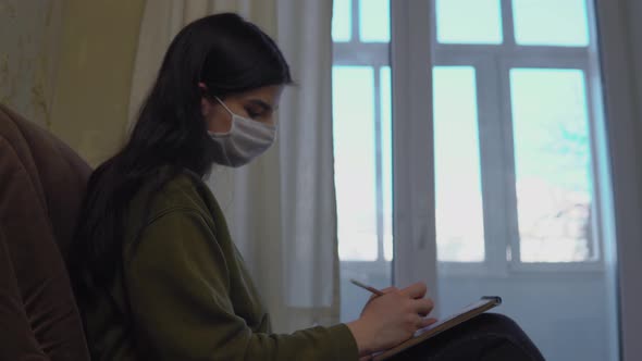 Woman in Medical Mask Stay Home Draws Painting in Sketchbook Quarantine