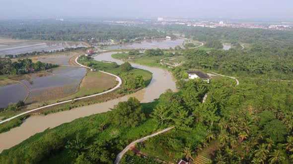 Aerial view curve river Sungai Perai pass the plantation