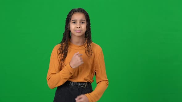 Cute African American Teen with Crossed Hands Looking to Camera Pointing at Herself Sticking Out