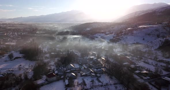 Winter Village and Highway with Cars in the Fog