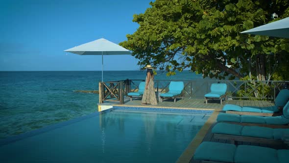 Curacao Couple on Vacation in Curacao Watching Sunset By the Pool