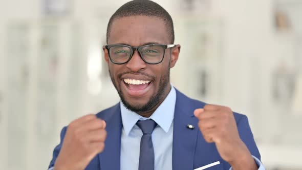 Portrait of Excited African Businessman Celebrating Success