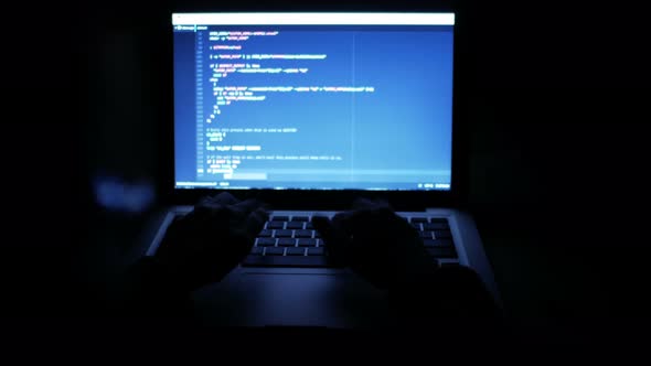 Hacker Stealing Data On Computer At Night