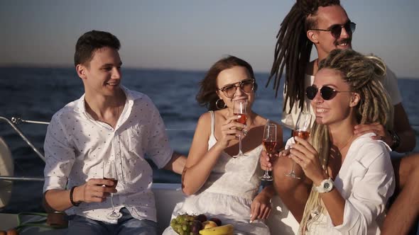 Cheerful Friends or Couples Spend a Weekend on a Yacht