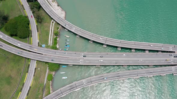 Top aerial view of Penang Bridge Malaysia with the first segment from the island seen with lite traf