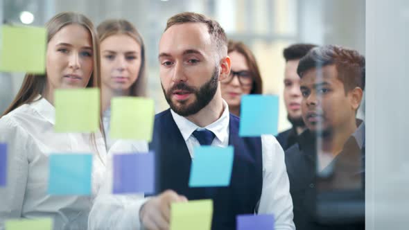 Multiethnic Business People Team Meeting and Brainstorming Working with Multi Colored Stickers Notes