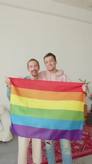 Two Attractive Men are Showing Lgbt Flag Looking at Each Other and Smiling