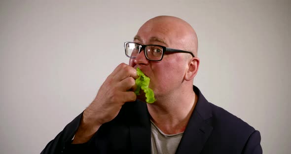 Portrait Bald Man in Glasses and Suit Greedily Eating Green Salad Vegetarian Diet