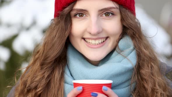 Close-up Portrait of Nice-Looking Curly Caucasian Elegant Young Woman Looking Into Camera