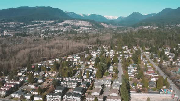 Aerial flying over an idyllic mountainside residential neighborhood.