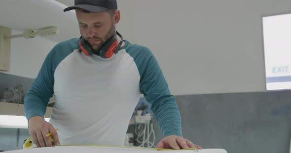 Male surfboard maker in his workshop