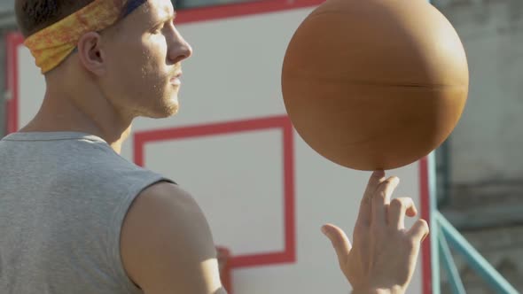 Handsome Guy Spinning Basketball on His Finger, Showing Professionalism, Sport