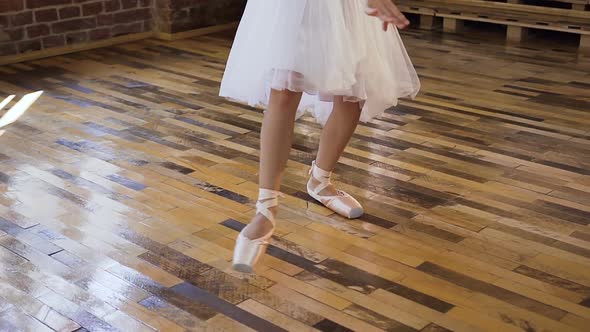 Young Ballet Dancer in White Ballet Shoes