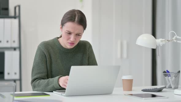 Young Woman with Laptop Reacting to Loss