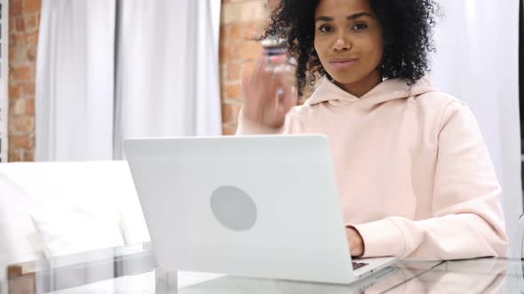 Sign of Okay Gesture By Young AfroAmerican Woman at Work