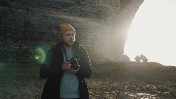 Excited Male Photographer Taking Photos of Amazing Rocky Normandy Beach Near Sunny Etretat Seaside