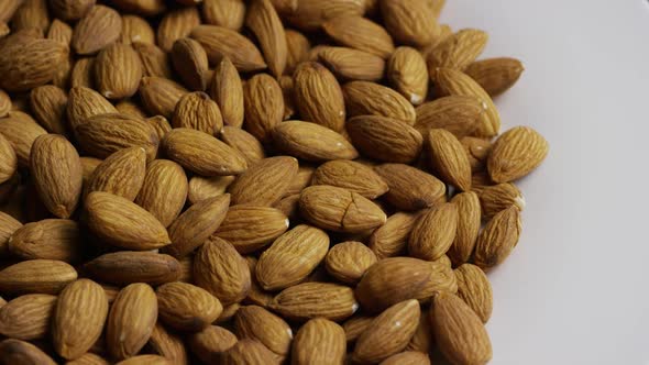 Cinematic, rotating shot of almonds on a white surface - ALMONDS 023