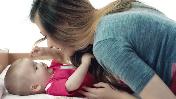 Pretty Young Mother Playing with Her Daughter