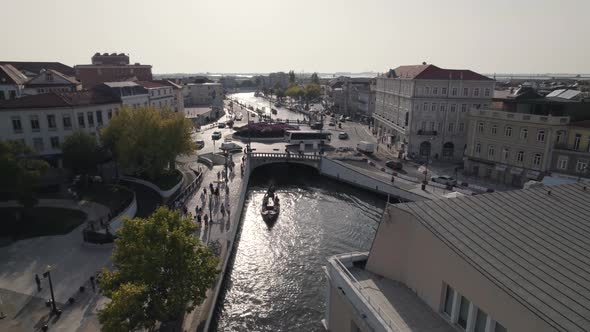 Moliceiro boat cruising on the main canal in the historic centre of Aveiro, Portugal.