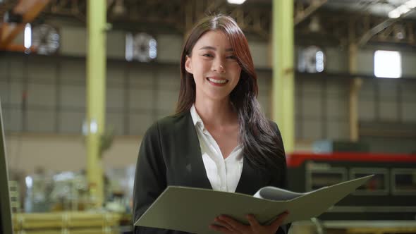 Portrait of Asian business woman work in industry manufacturing plant.