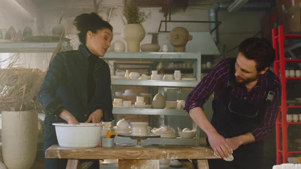 Colleagues Are Cleaning Up Tools In Pottery Studio