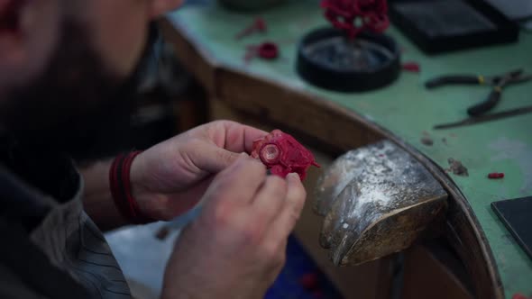 Male Hands Creating Jewellery Decoration in Workshop Indoors
