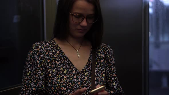 Close Shot of Young Attractive Ukraine Female in Glasses Sitting on Moving City Metro Train