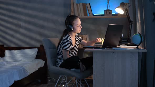 Girl Student Attending Online Class During Lockdown at Night Participate in Class Using Laptop and