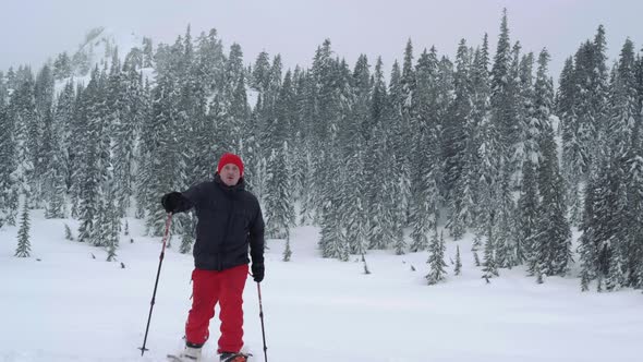 Determined Splitboarder Hiking Fresh Powder Snow In Mountain Landscape