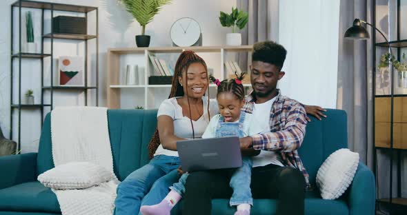 Afro American Family Playing Games on Laptop at Home