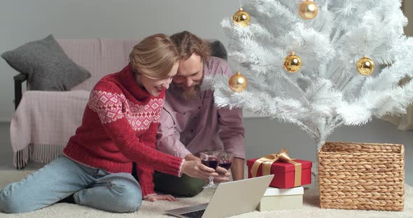 Caucasian Young Family of Millennials Bearded Man and Blonde Woman Sitting Together Near Christmas