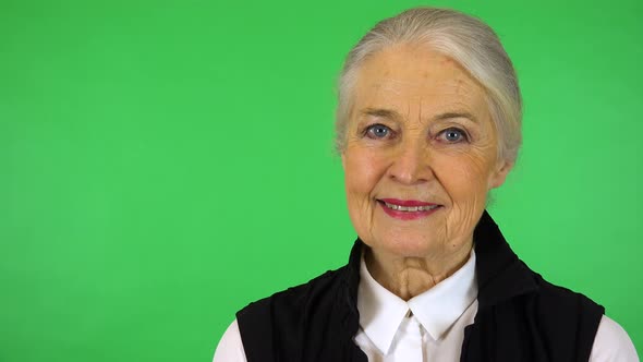 An Elderly Woman Smiles at The Camera