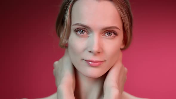 Smiling Beautiful Young Woman with Perfect Tender Body Face Skin Posing Isolated on Red Gradient