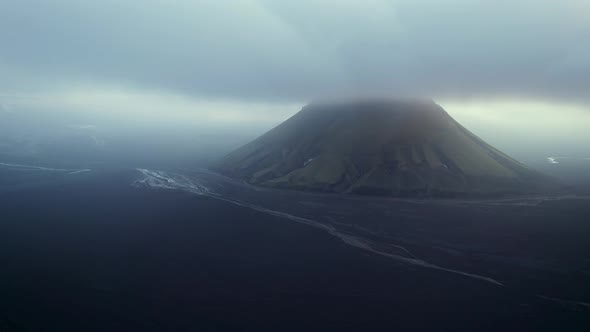 Mountain surrounded by clouds in evening