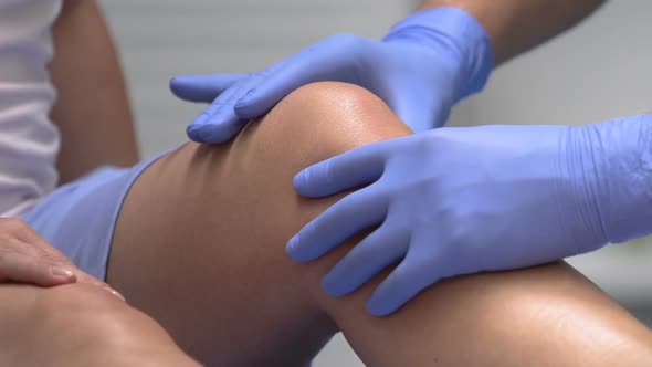 Doctor Palpating Patient Knee, Traumatologist Examination After Trauma, Health