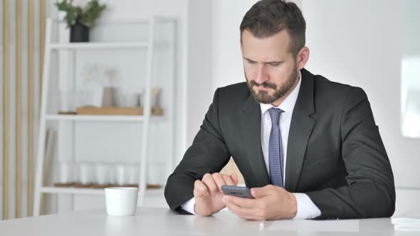 Businessman Using Smartphone for Online Trading