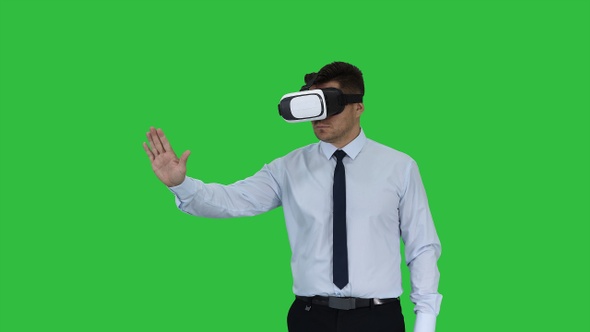 Businessman in VR glasses and interacting with virtual