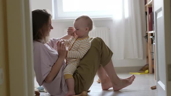 Little Baby Girl and Mommy Playing at Home Sitting on Floor