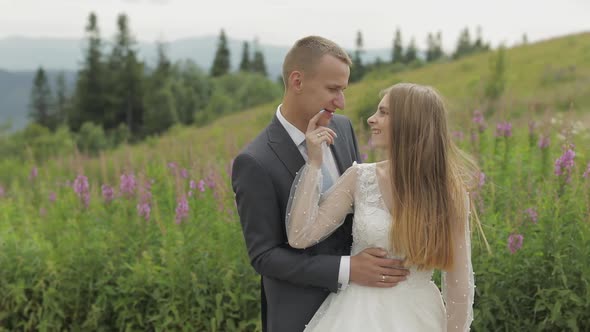 Groom with Bride Together on a Mountain Hills. Wedding Couple. Happy Family