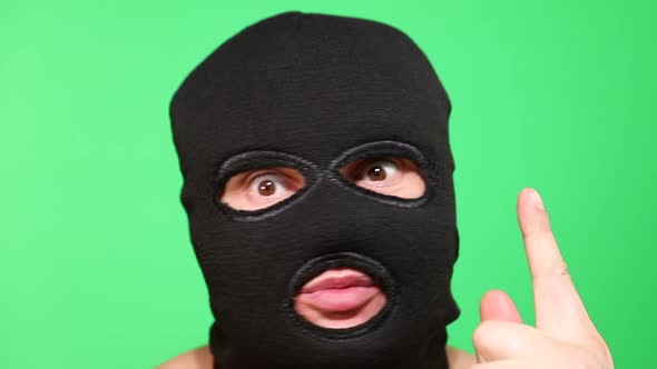 Scary Thief or Robber in Mask Looking at Camera