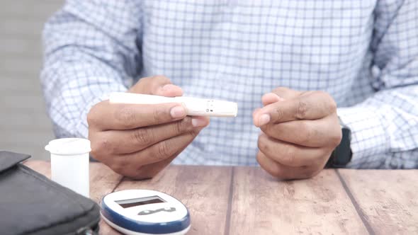 Man's Hand Measuring Blood Sugar Level