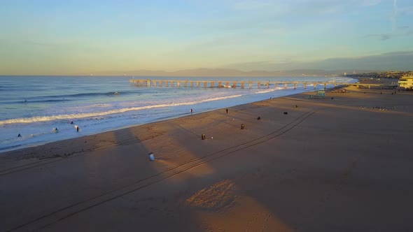 Aerial drone uav view of a lifeguard tower, pier, beach and ocean.