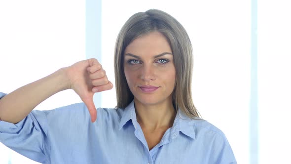 Portrait of Upset Young Woman Gesturing Thumbs Down