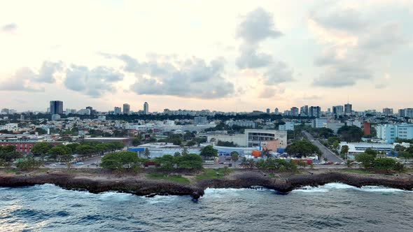 Promenade of Malecon with obelisk in Center of Heroes park and Agua y Luz theater. Aerial sideways