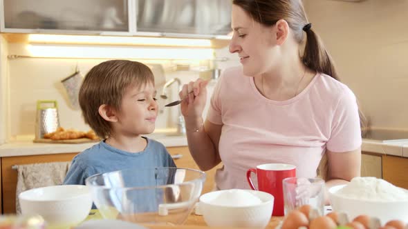 Little Boy with Mother Pouring Cream and Sugar in Bowl for Baking Cake