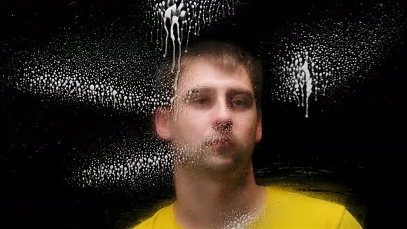 A Young Man Sprays an Antibacterial Spray and Then Wipes the Glass with a Disinfectant Wipe To Kill