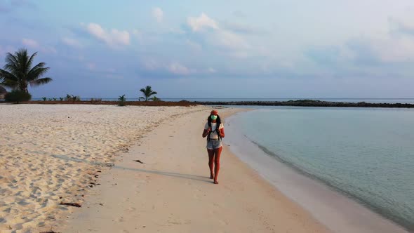 Women happy together on luxury coast beach holiday by blue green ocean with white sandy background o